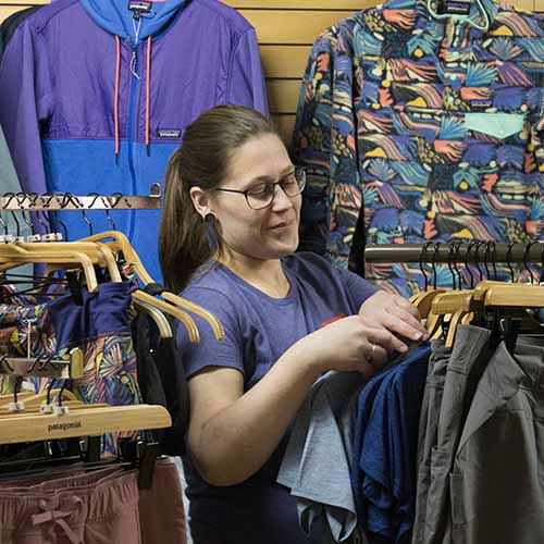 Woman standing in a clothing section of FarmWay
